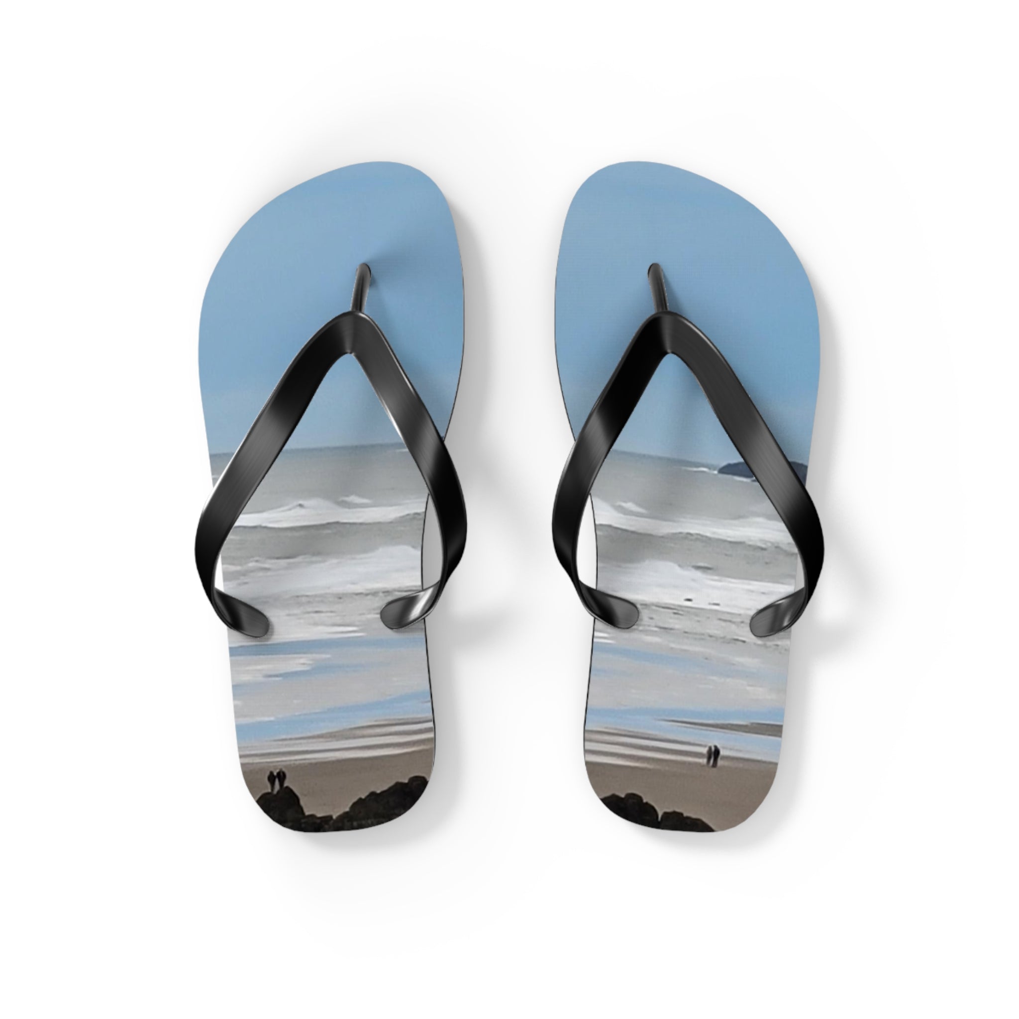 Flip-flops with a beach scene of people walking on the shore.