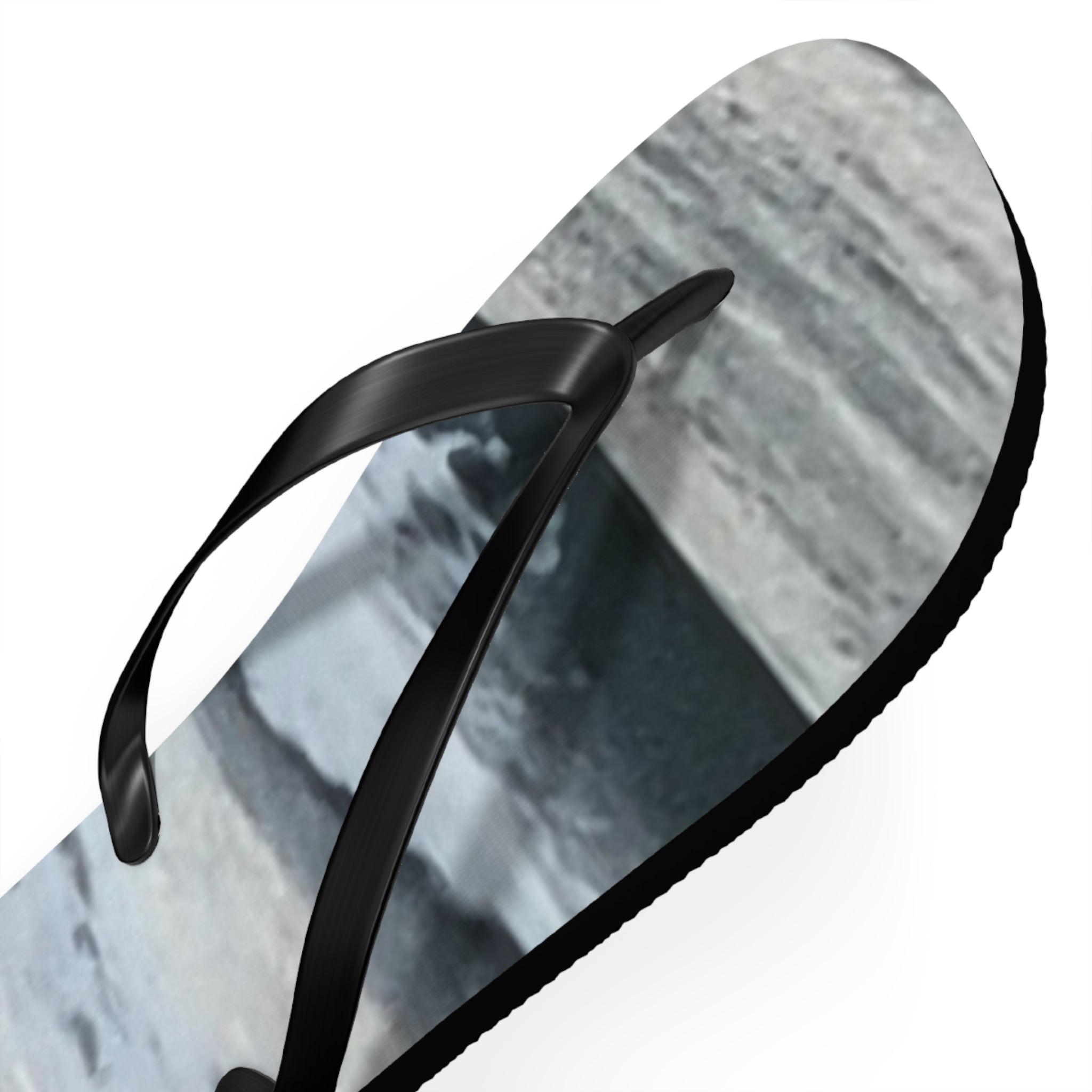 Black flip-flop with abstract grey and white pattern on the sole.