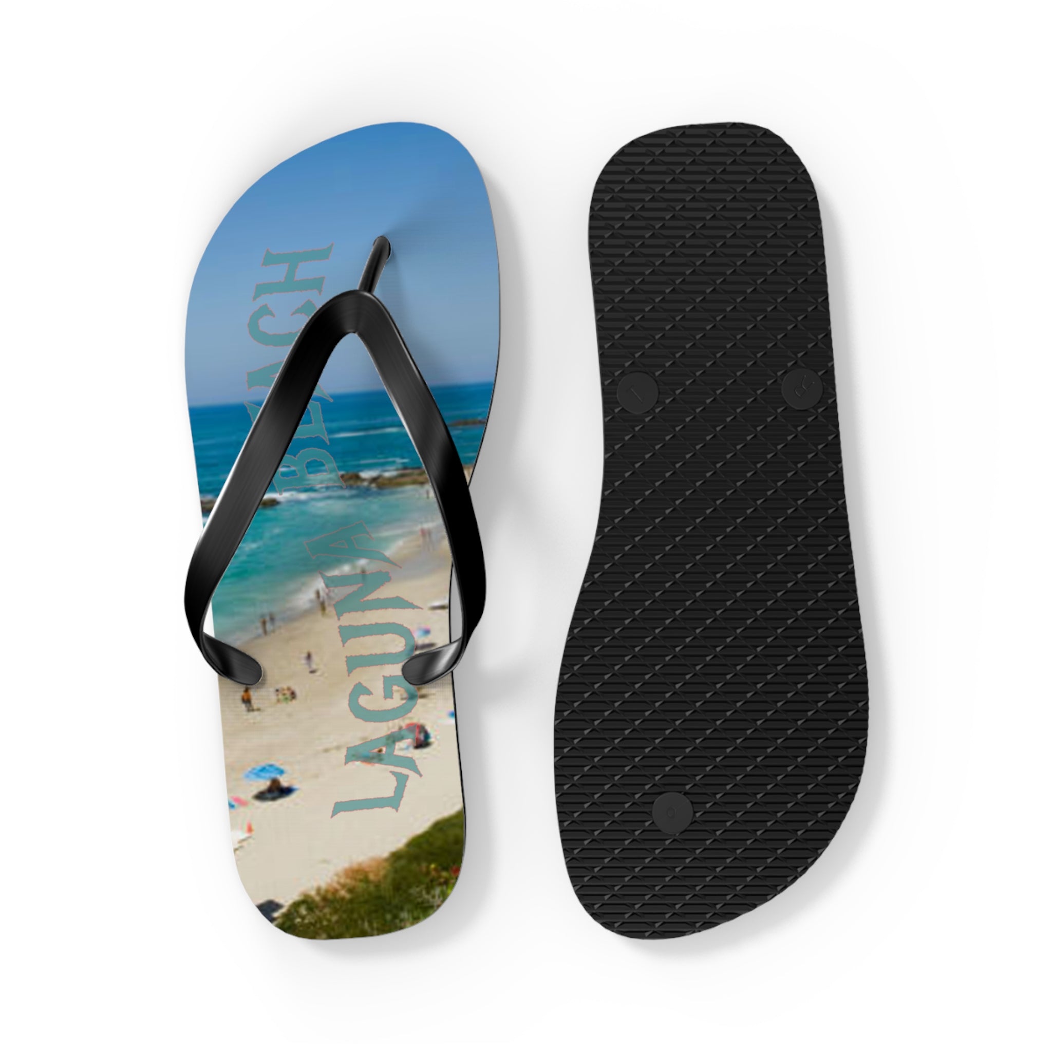 Flip-flops with "LAGUNA BEACH" text on sole, against a coastal backdrop.