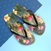 Flip-flops with a floral pattern of tulips and daffodils on a blue and white background.