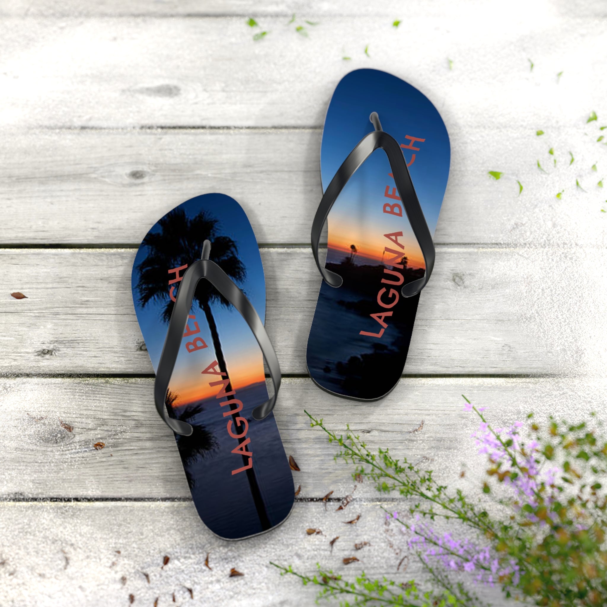 Flip-flops with "Laguna Beach" and palm tree sunset graphic.