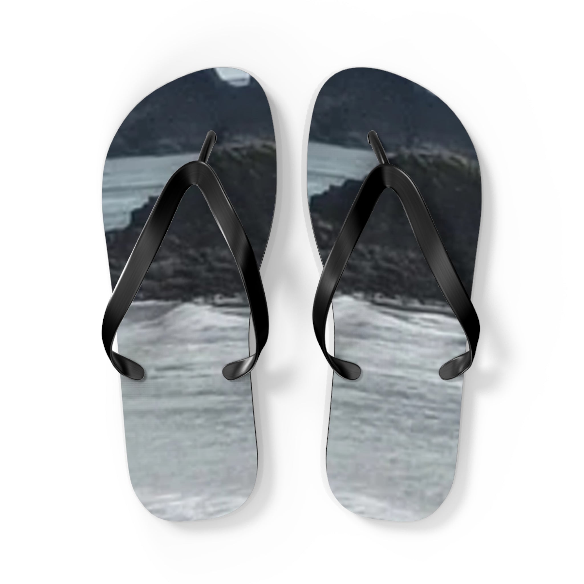 Flip-flops with a black strap and a scenic landscape design.