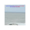 Quote about the sea and beauty over a calm ocean landscape.