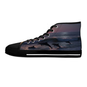 High-top sneakers with leaping dolphins and waves on a sunset background.
