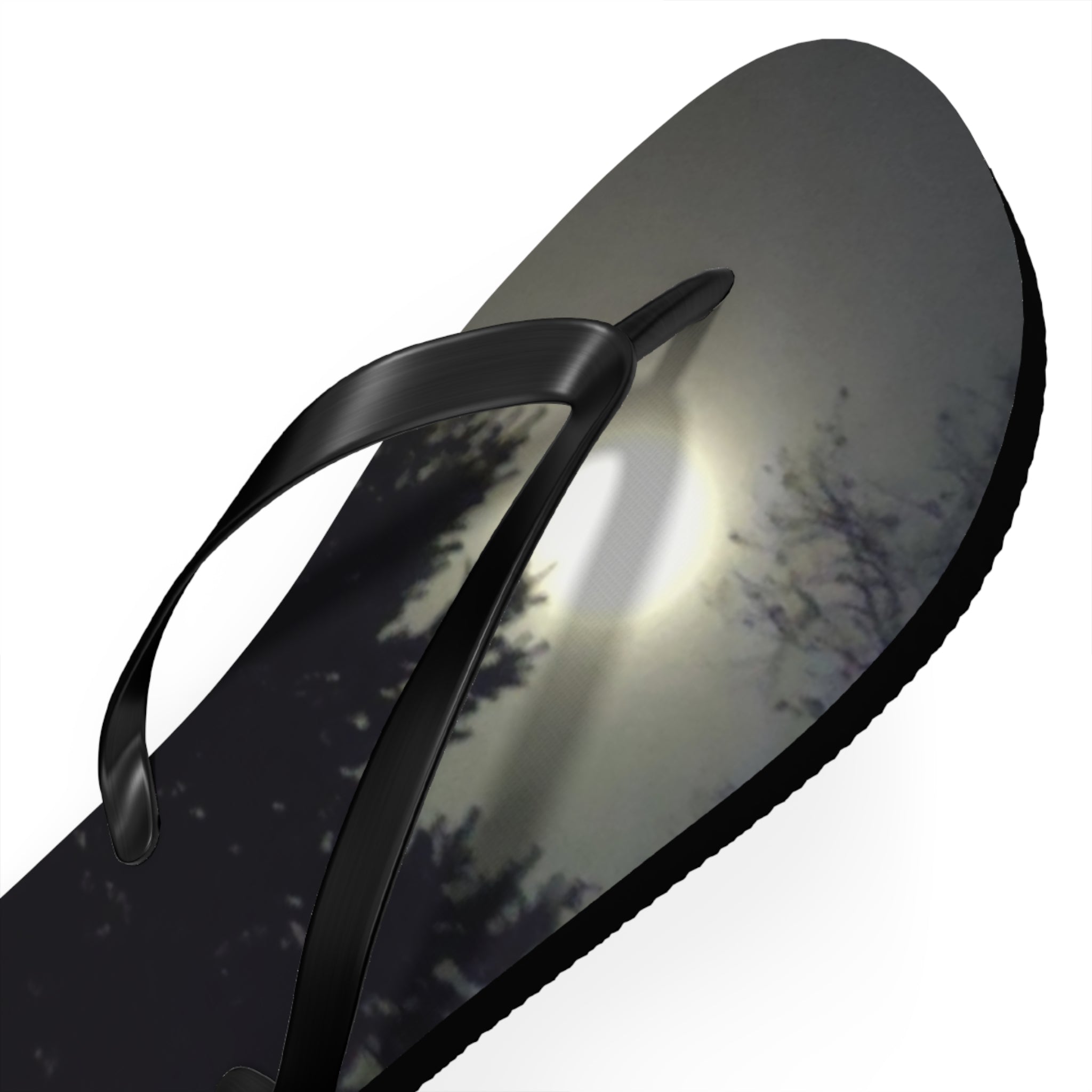 Black flip-flop with a moonlit forest scene on the sole.