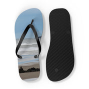 Black flip-flop with a beach scene on the sole, white background.