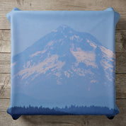 Pillow with a snowy mountain and forest silhouette.