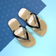Tan flip-flops with black straps on a blue and white background.