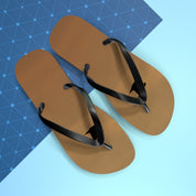 Brown flip-flops with black straps on a blue grid background.
