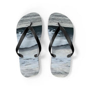 Flip-flops with a wavy water pattern and black straps.