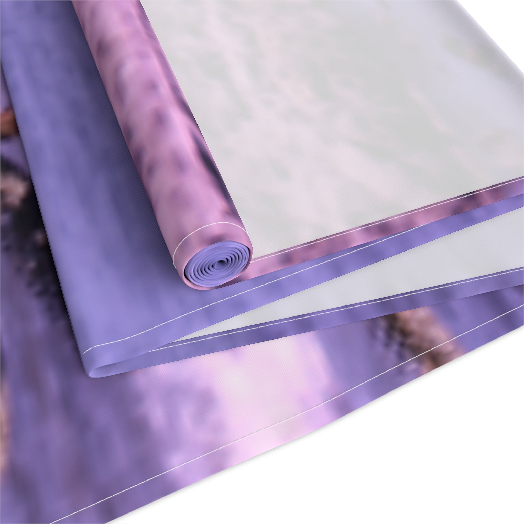 Rolled fabric with purple and white swirling pattern.