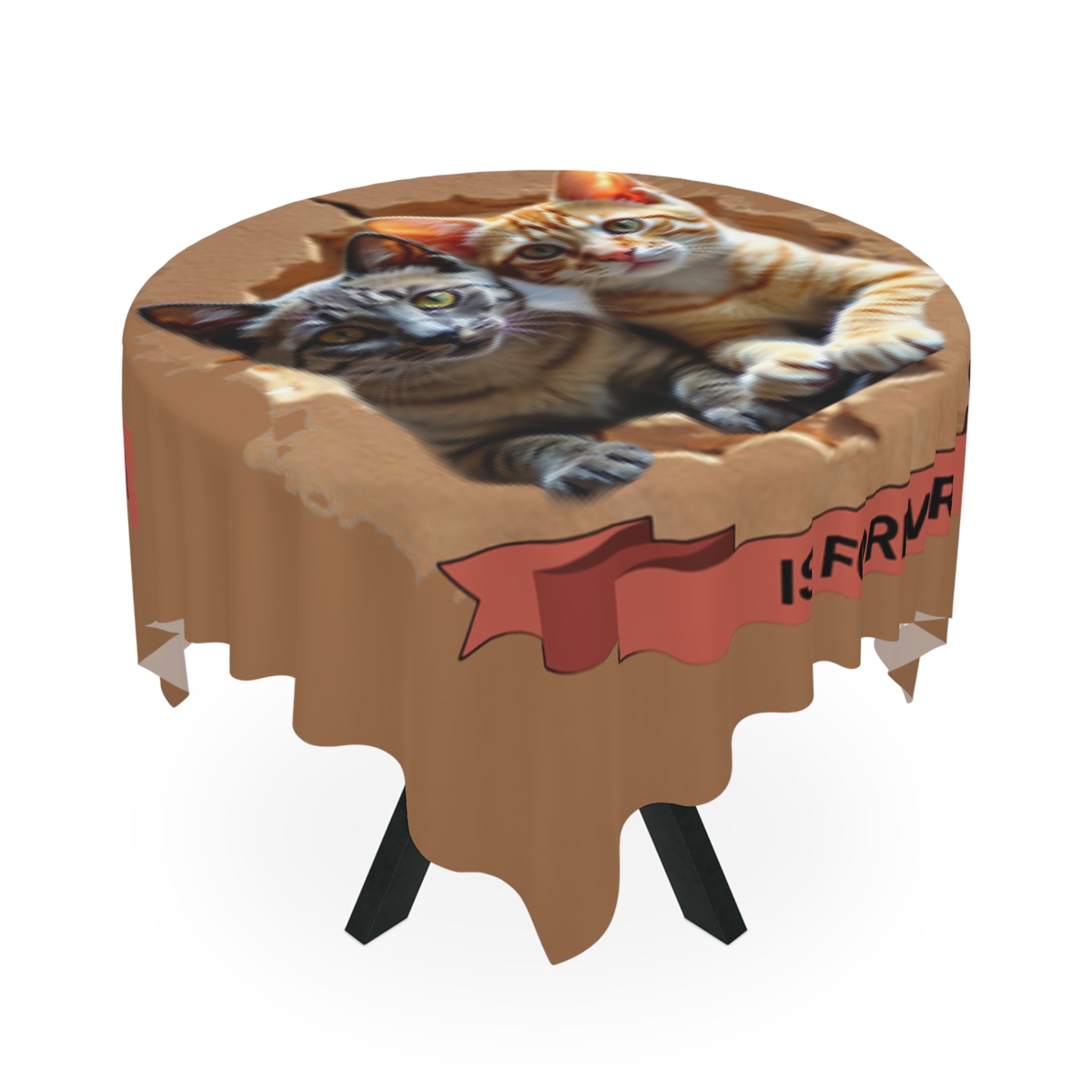 Two tabby cats peek out of a torn cardboard box on a round tablecloth.