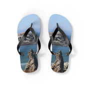 Flip flops with a rocky ocean landscape printed on the soles.