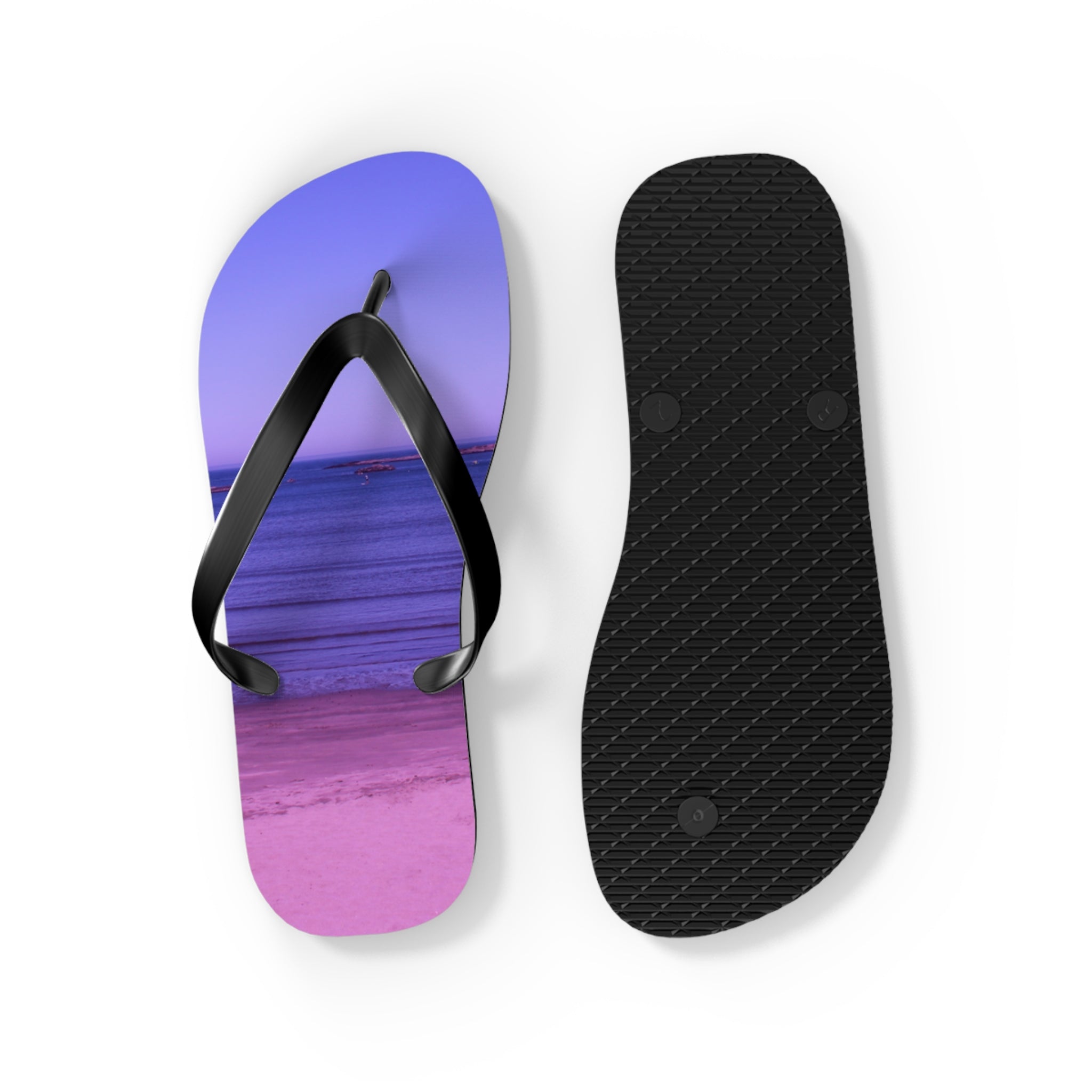 Two flip-flops, one with a beach sunset graphic, isolated on white.