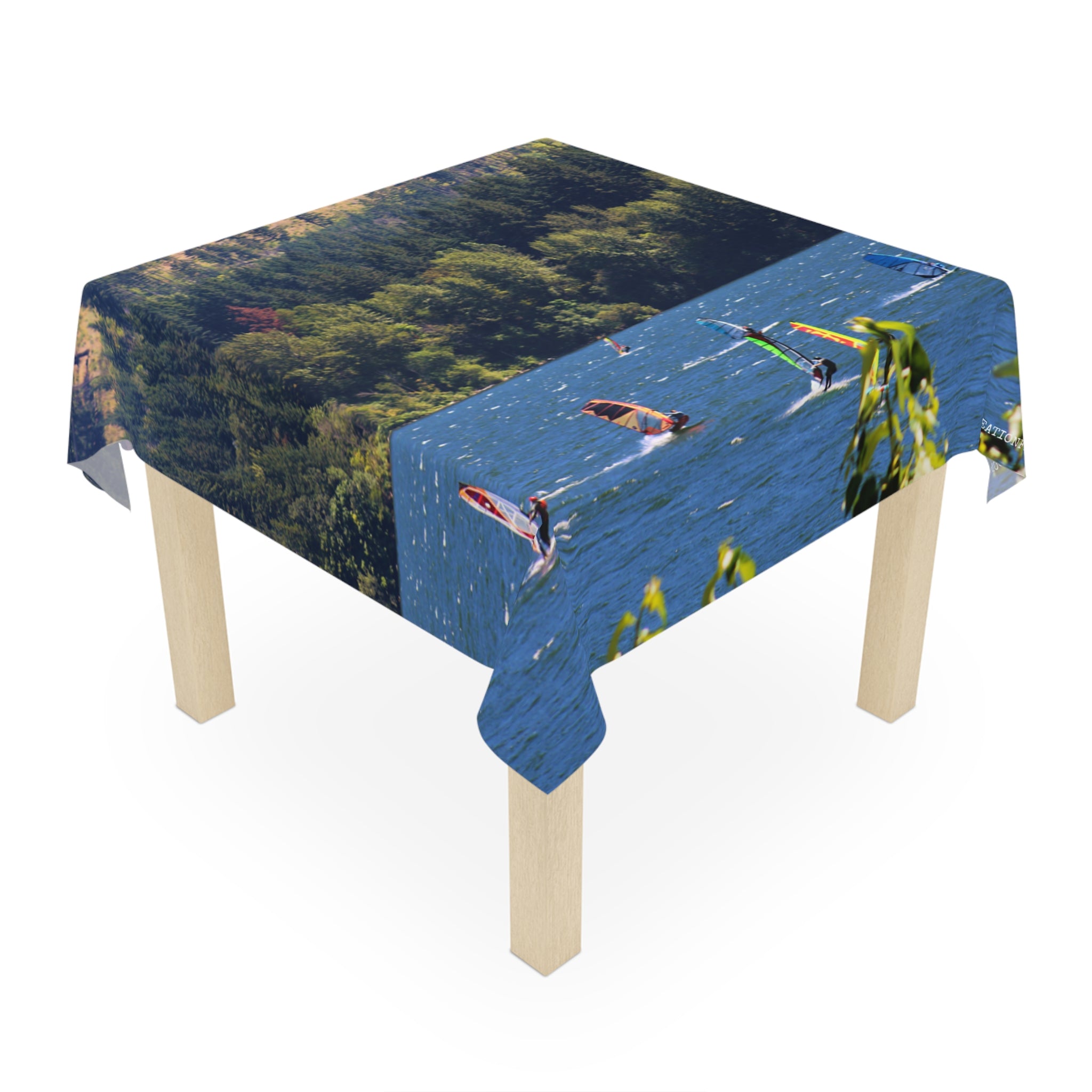 Tablecloth with windsurfers on a lake, forest in background.