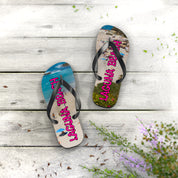 Flip flops with "Laguna Beach" printed on them, on a wooden surface.
