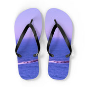 Lavender flip-flops with ocean scene on soles, isolated on white.