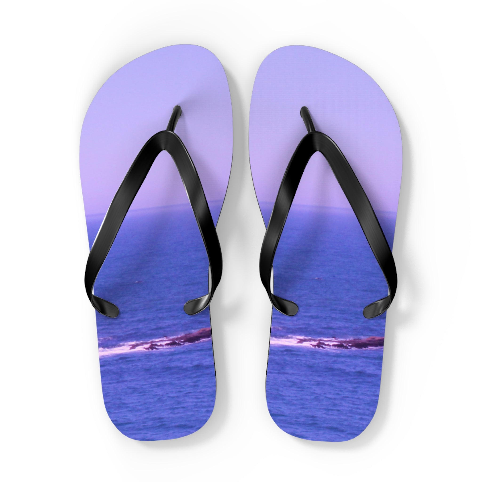 Lavender flip-flops with ocean scene on soles, isolated on white.