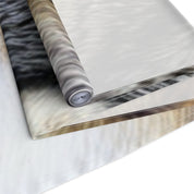 Rolled fabric with a close-up of gray and white fur pattern.