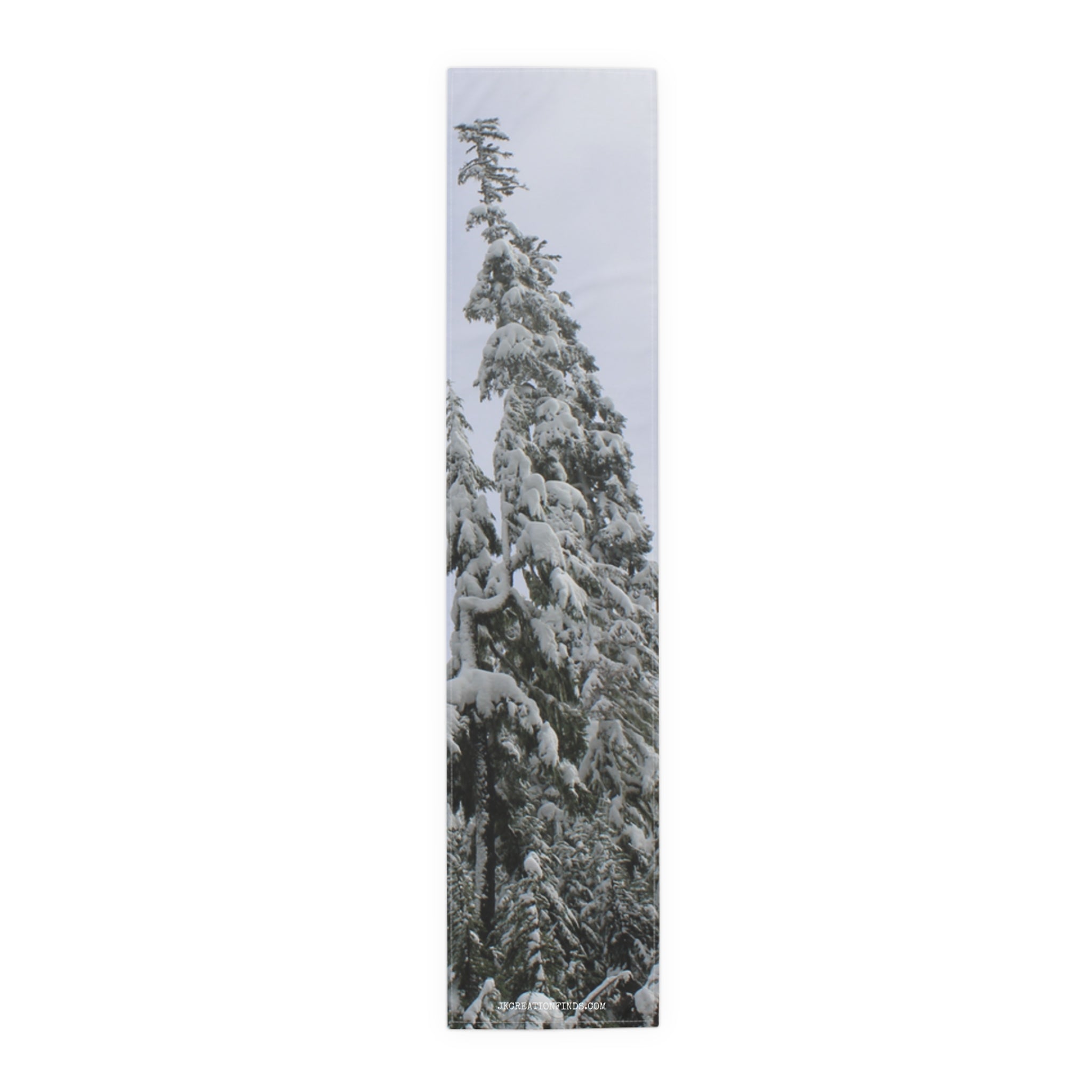 Tall evergreen tree covered in snow against a muted sky.