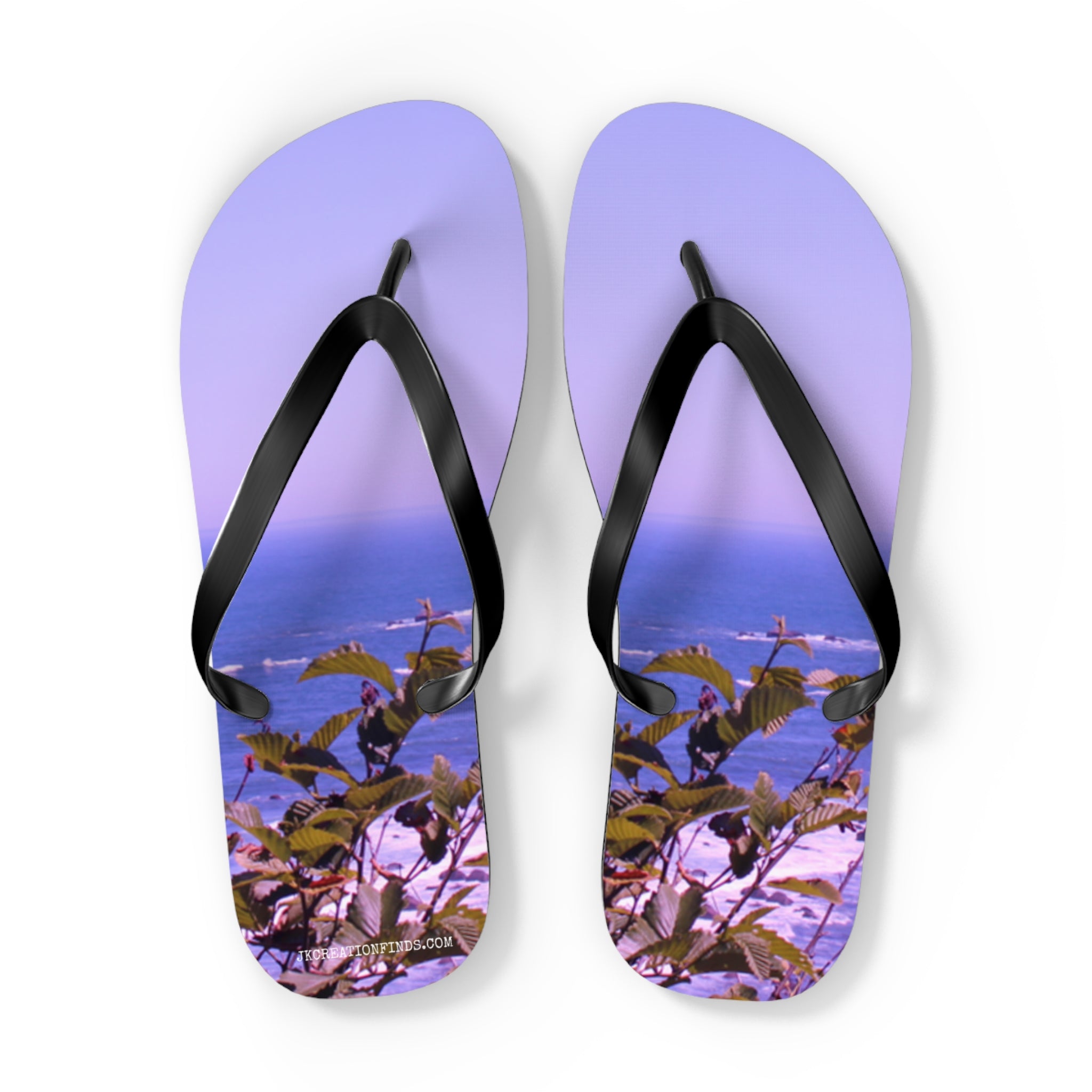 Purple flip-flops with a coastal foliage scene and a subtle watermark.