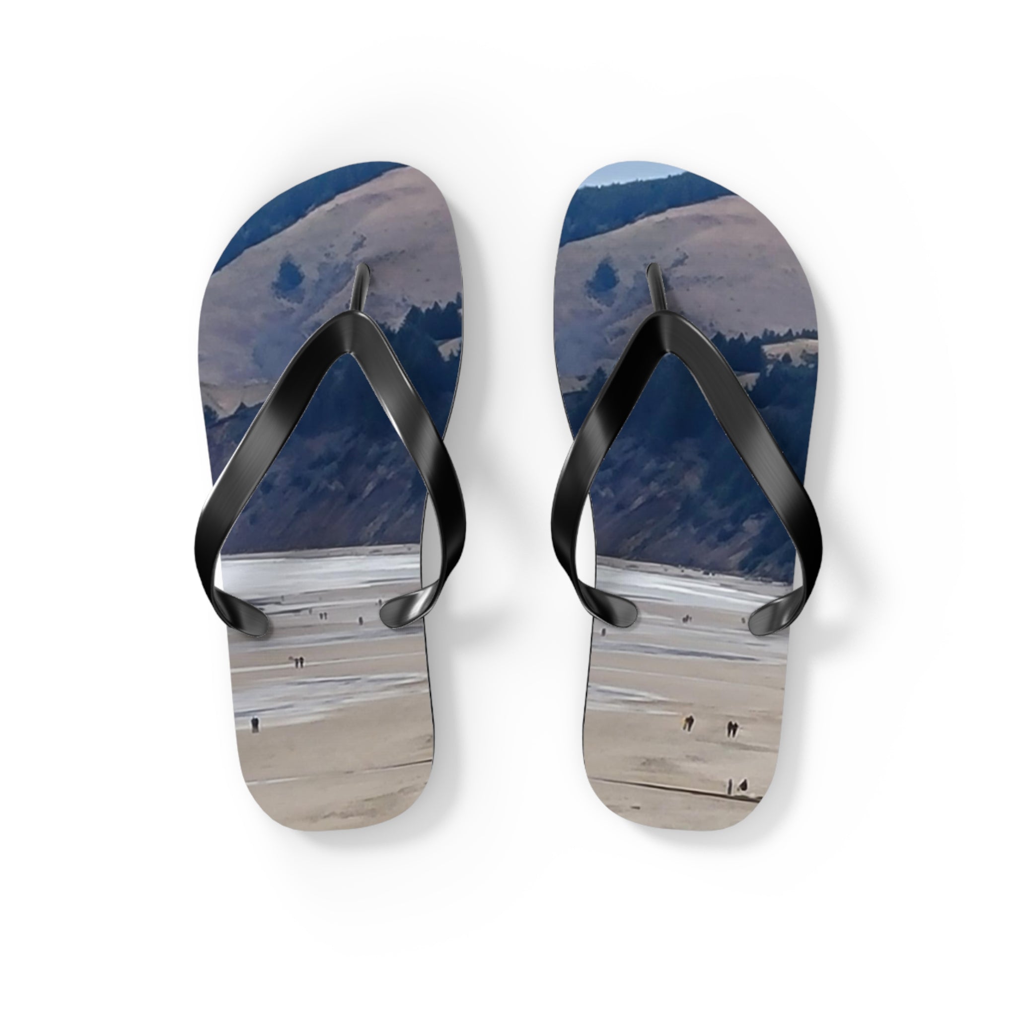 Flip-flops with a beach landscape and people walking on sand.