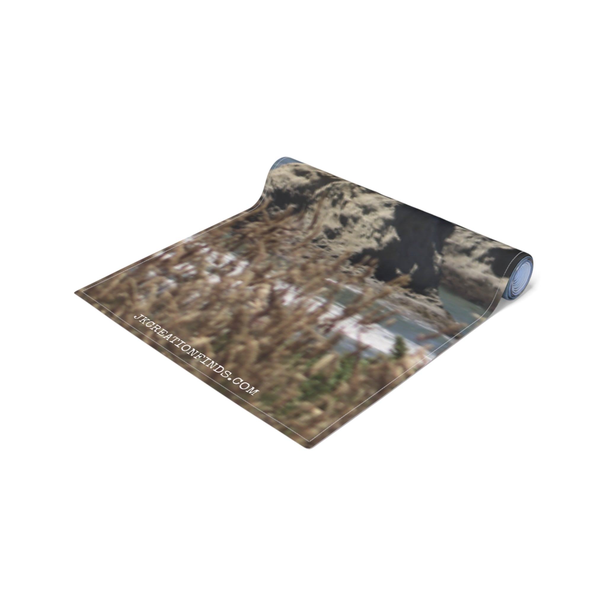 Rolled yoga mat with a natural landscape and "JKCREATIONFINDS.COM" text.