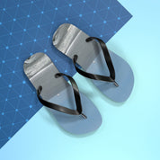 Pair of light blue flip-flops with black straps on a blue background.