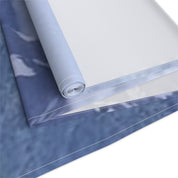 Rolled fabric with marbled blue and white pattern.