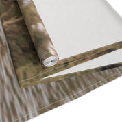 Rolled fabric banner with stitched edges and blurred forest background.