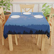 Dark blue tablecloth with misty forest and mountain silhouette.