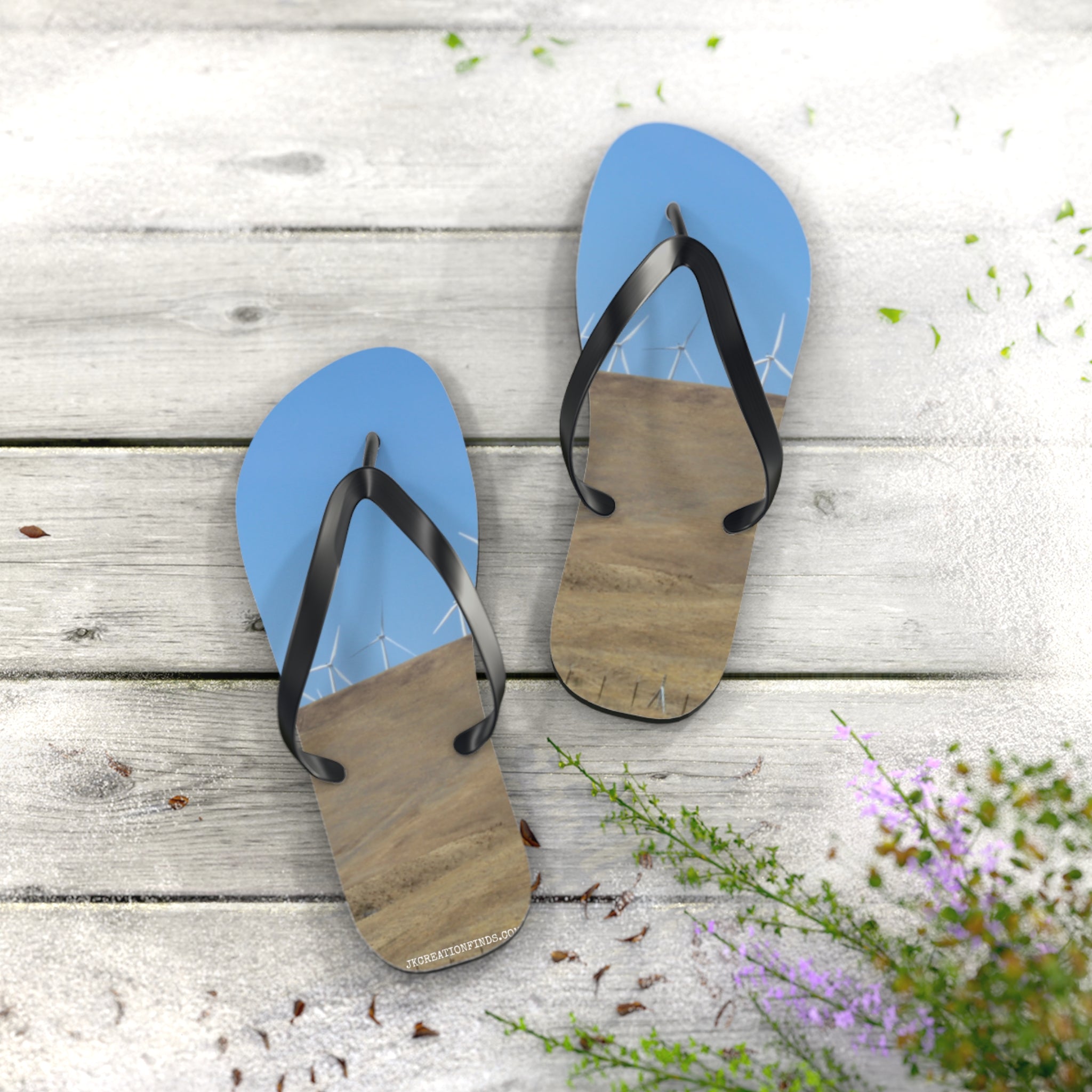 Flip-flops with a wind turbine and beach landscape on the soles.