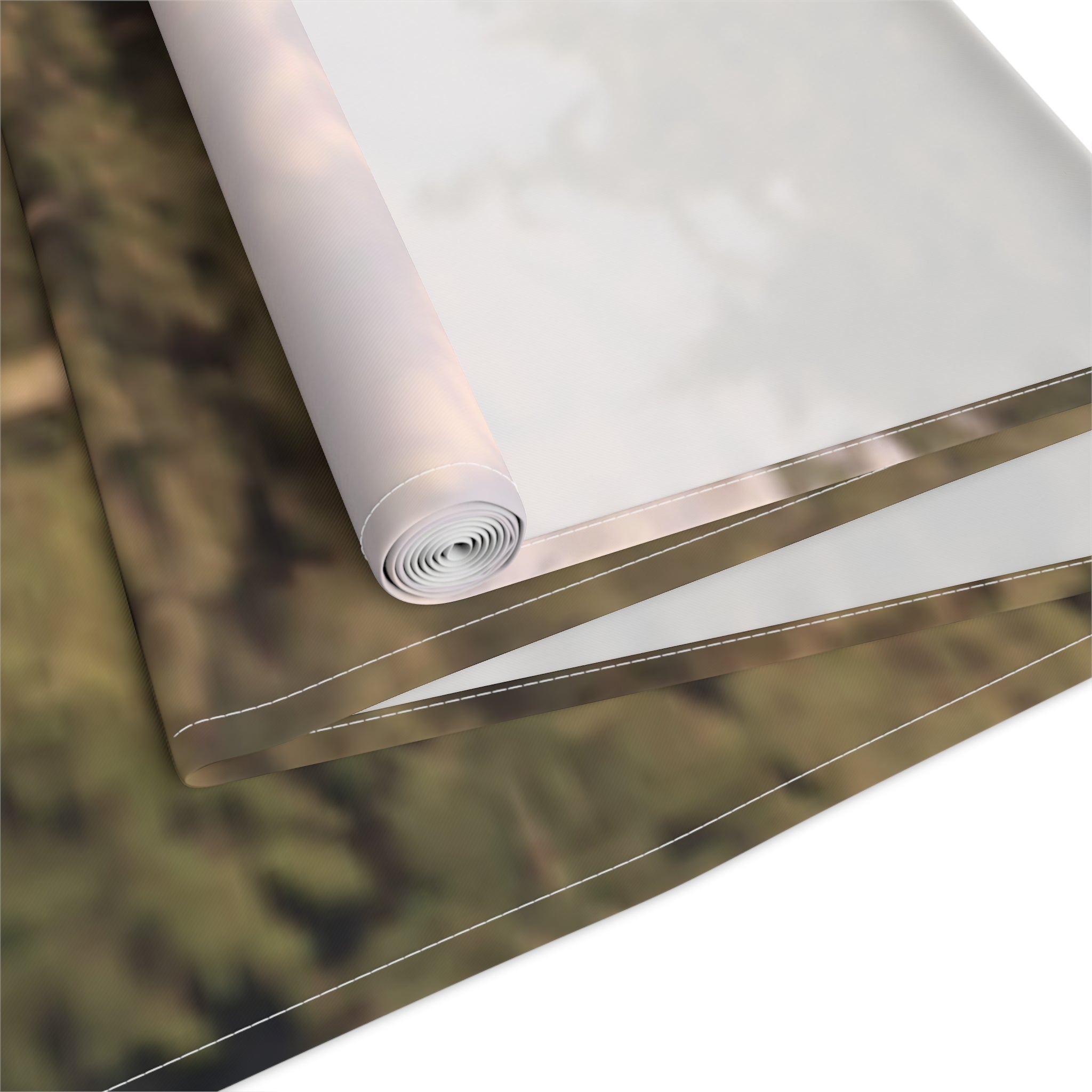 Rolled canvas with white edge detail and blurred green background.