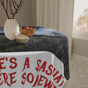 Tablecloth with red text "THERE'S A SAUCY SIDE" on a draped table.