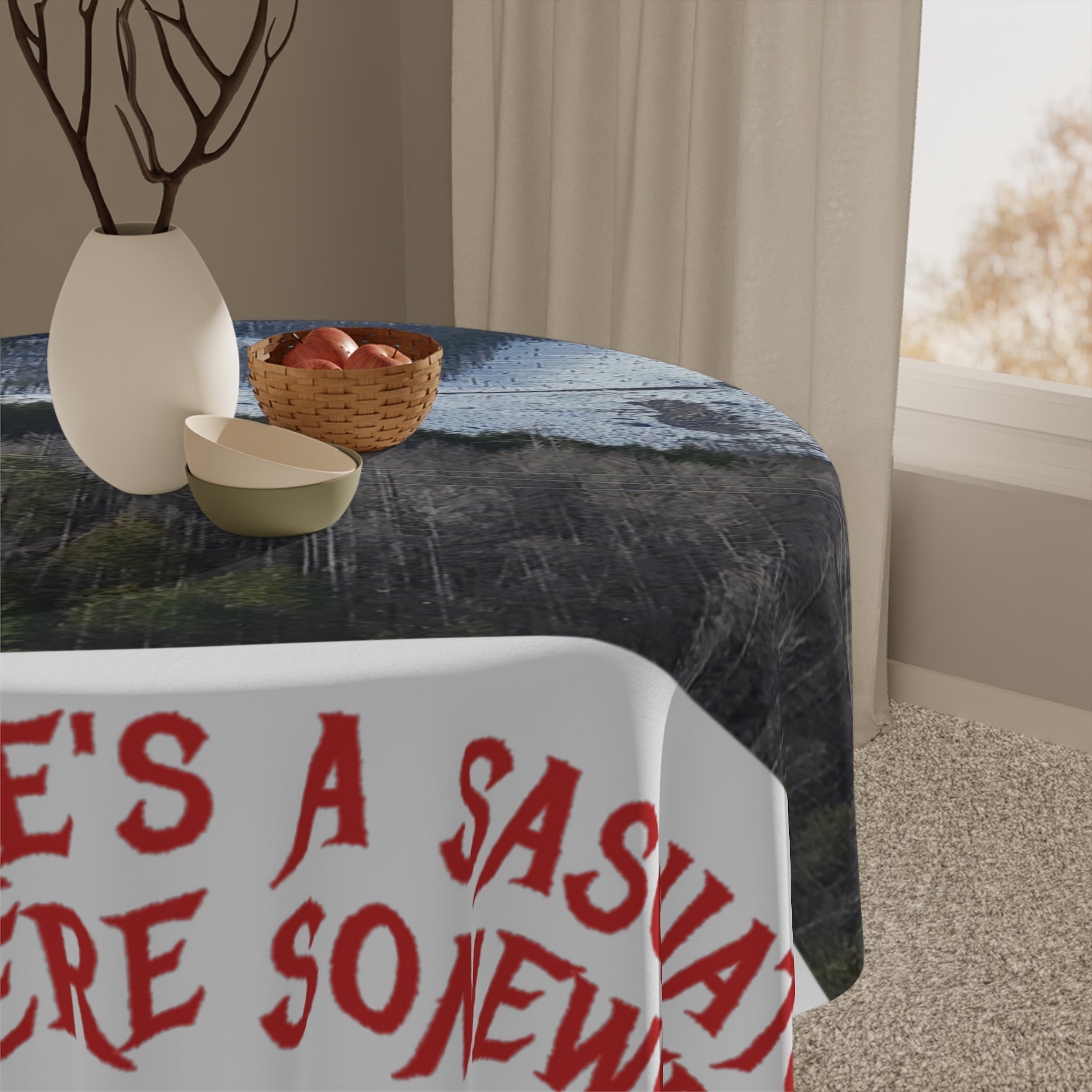 Tablecloth with red text "THERE'S A SAUCY SIDE" on a draped table.