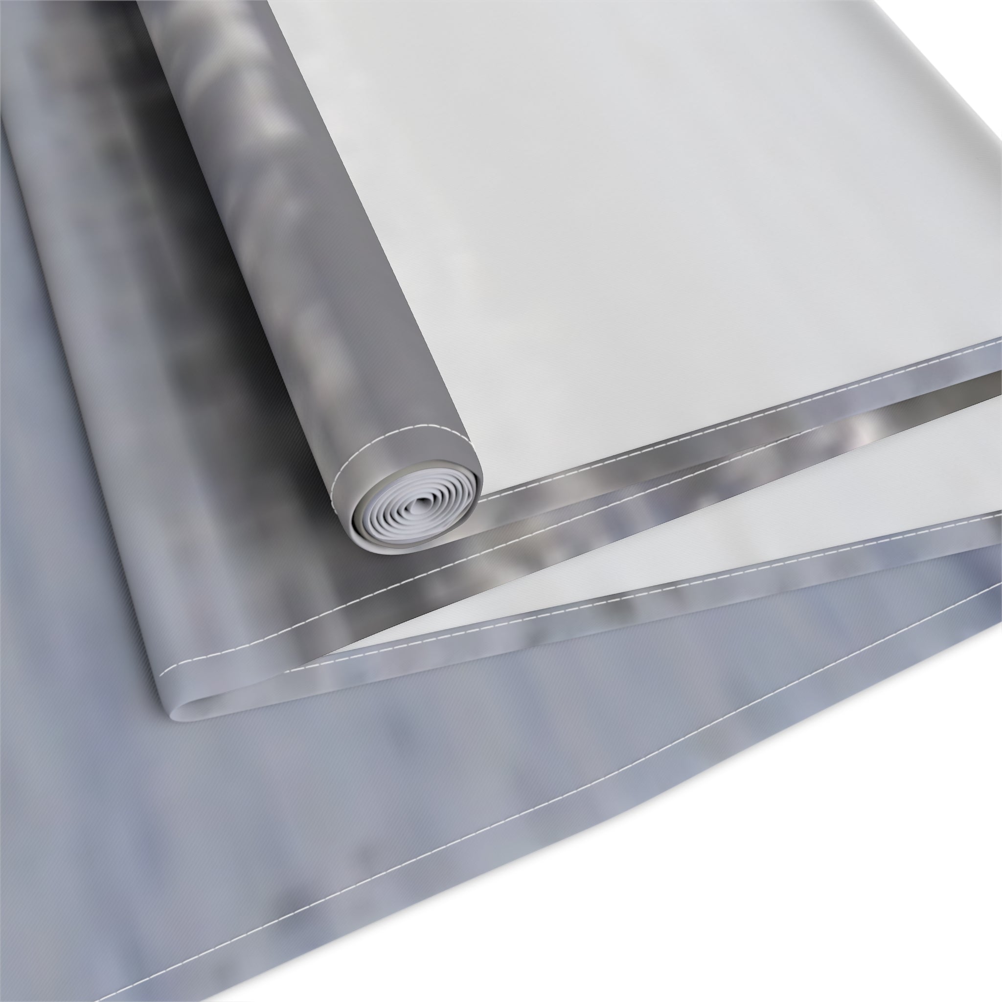 Rolled silver fabric with white stitching on white background.
