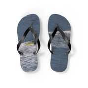 Flip-flops with a surfer on a wave design.