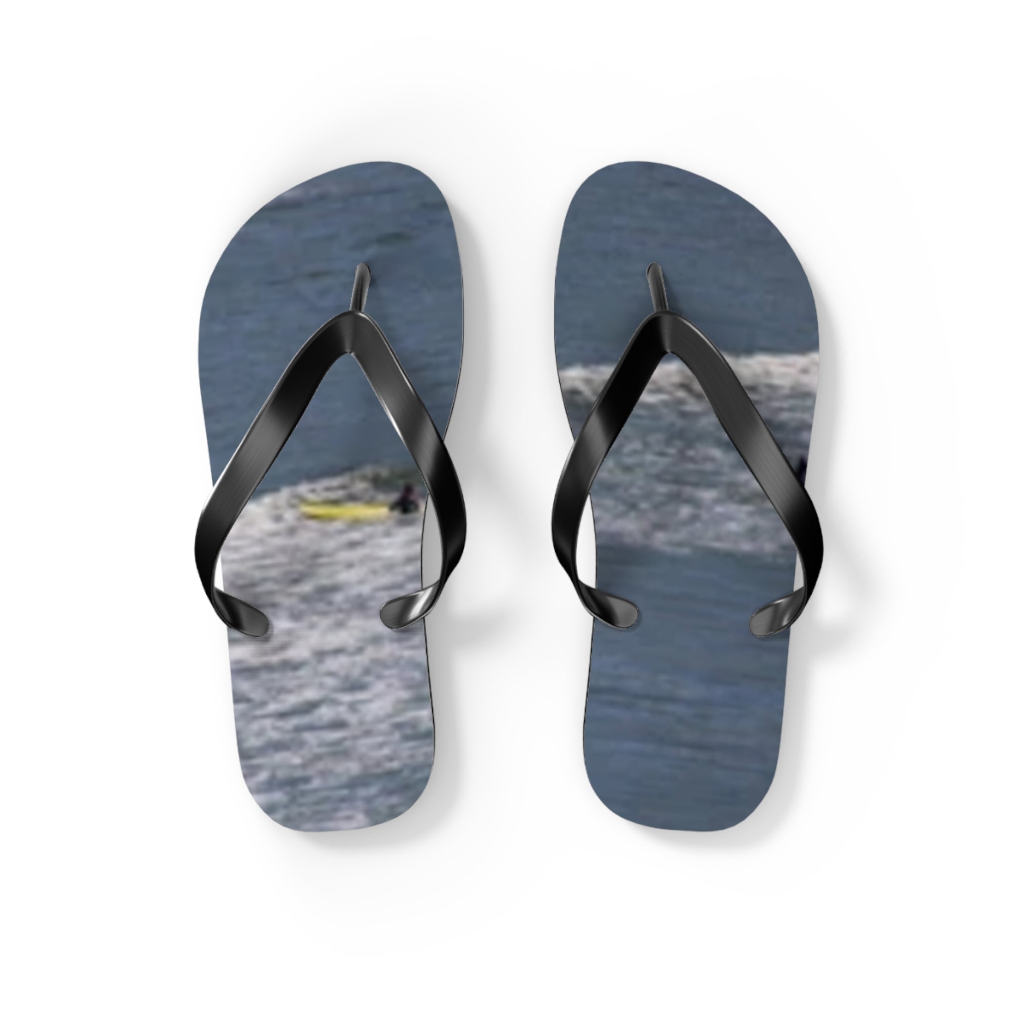 Flip-flops with a surfer on a wave design.