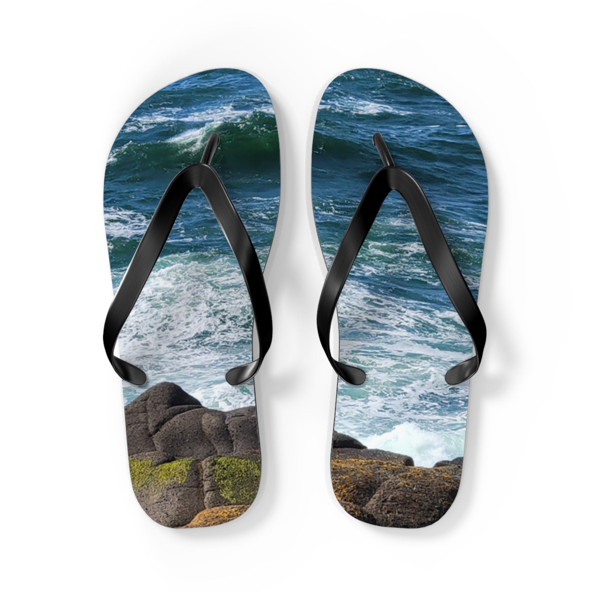Flip-flops with a rocky ocean wave design on a white background.