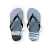 Light blue flip-flops with a tropical ocean and green cliffs scene.