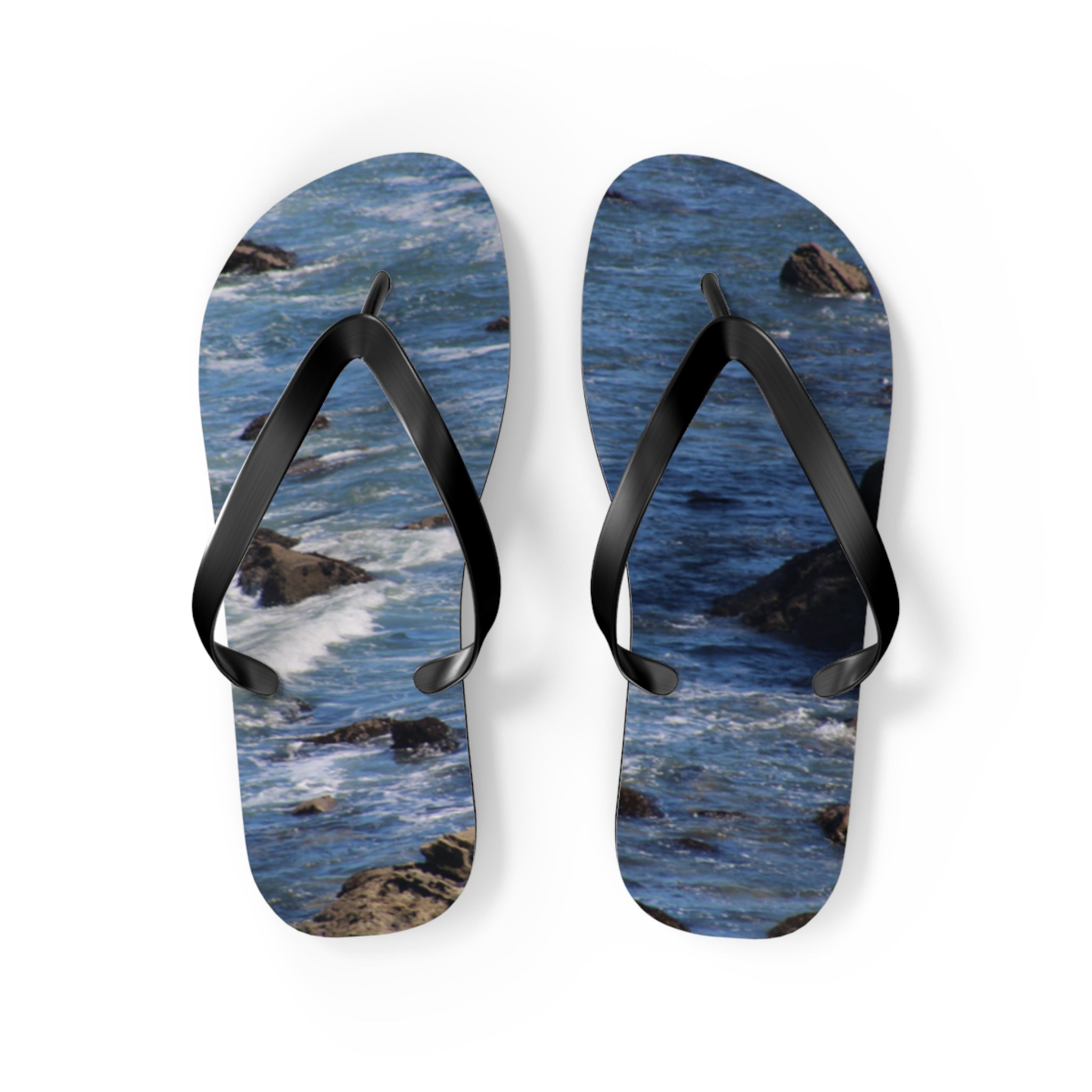 Flip-flops with ocean waves and rocks pattern.