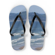 Flip-flops with a beach and ocean scene printed on the footbeds.