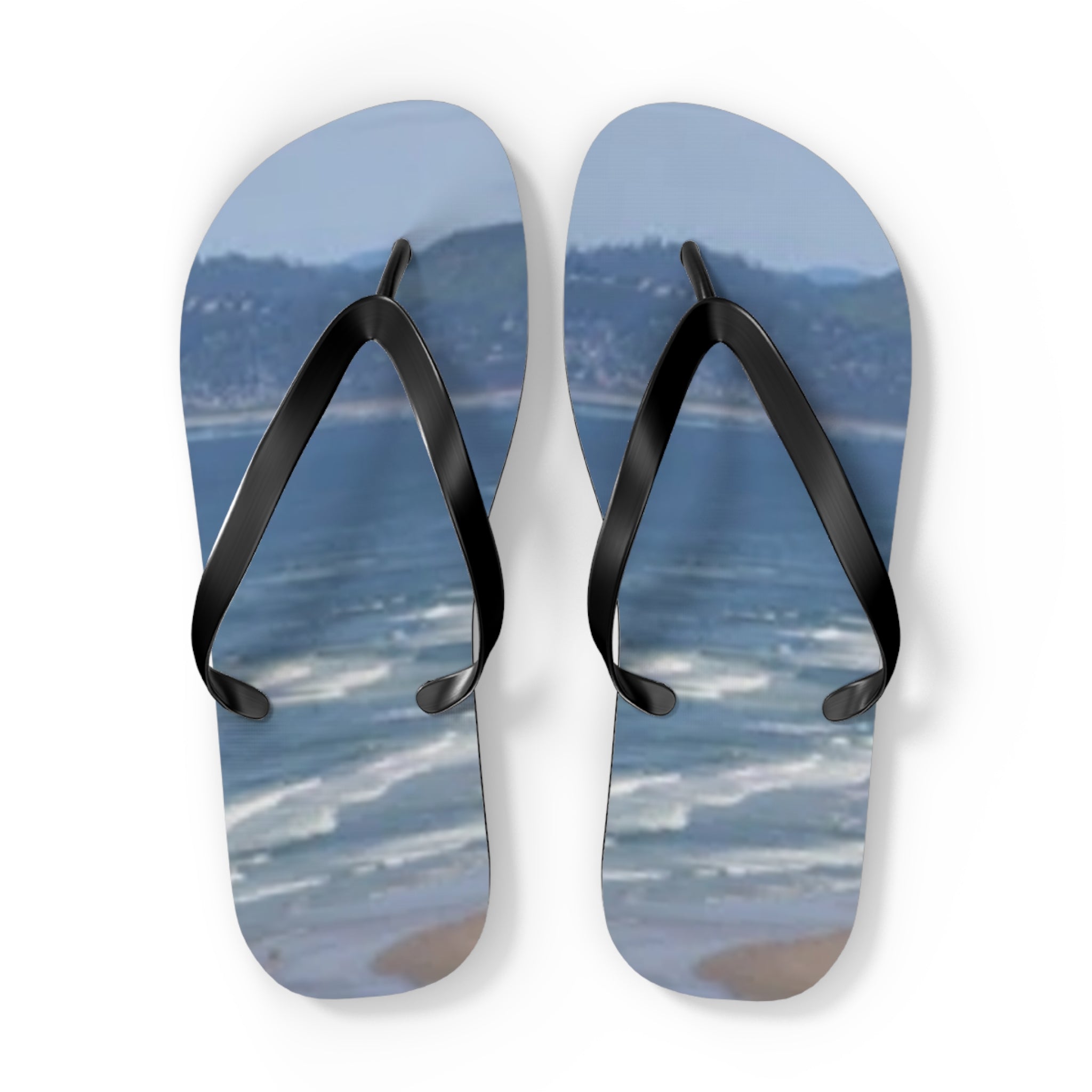 Flip-flops with a beach and ocean scene printed on the footbeds.