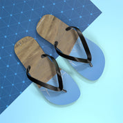 Flip-flops with a beach and wind turbine scene on a blue grid.