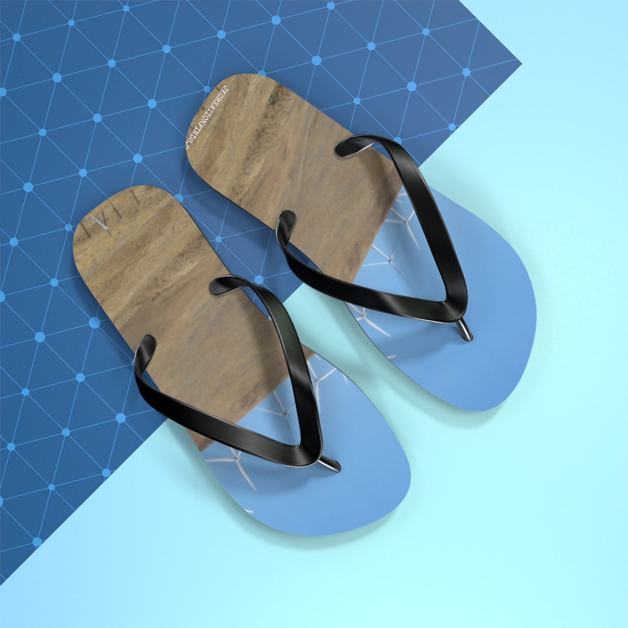 Flip-flops with a beach and wind turbine scene on a blue grid.