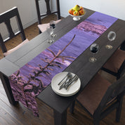 Purple tree branch table runner with water and fruit bowl.