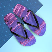 Purple abstract patterned flip-flops with black straps on a blue background.