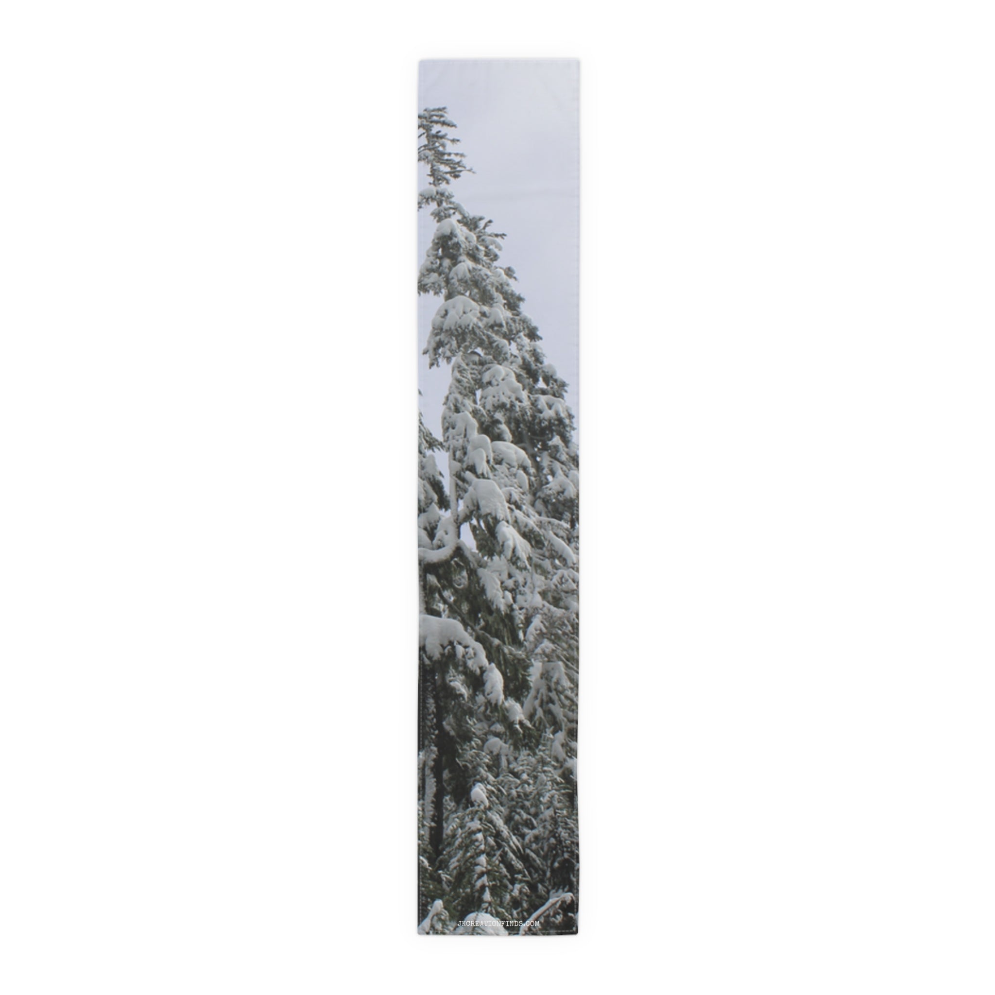 Tall snow-covered evergreen tree against a white sky.
