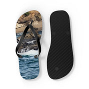 Flip-flops with ocean waves and rocky shore scene.