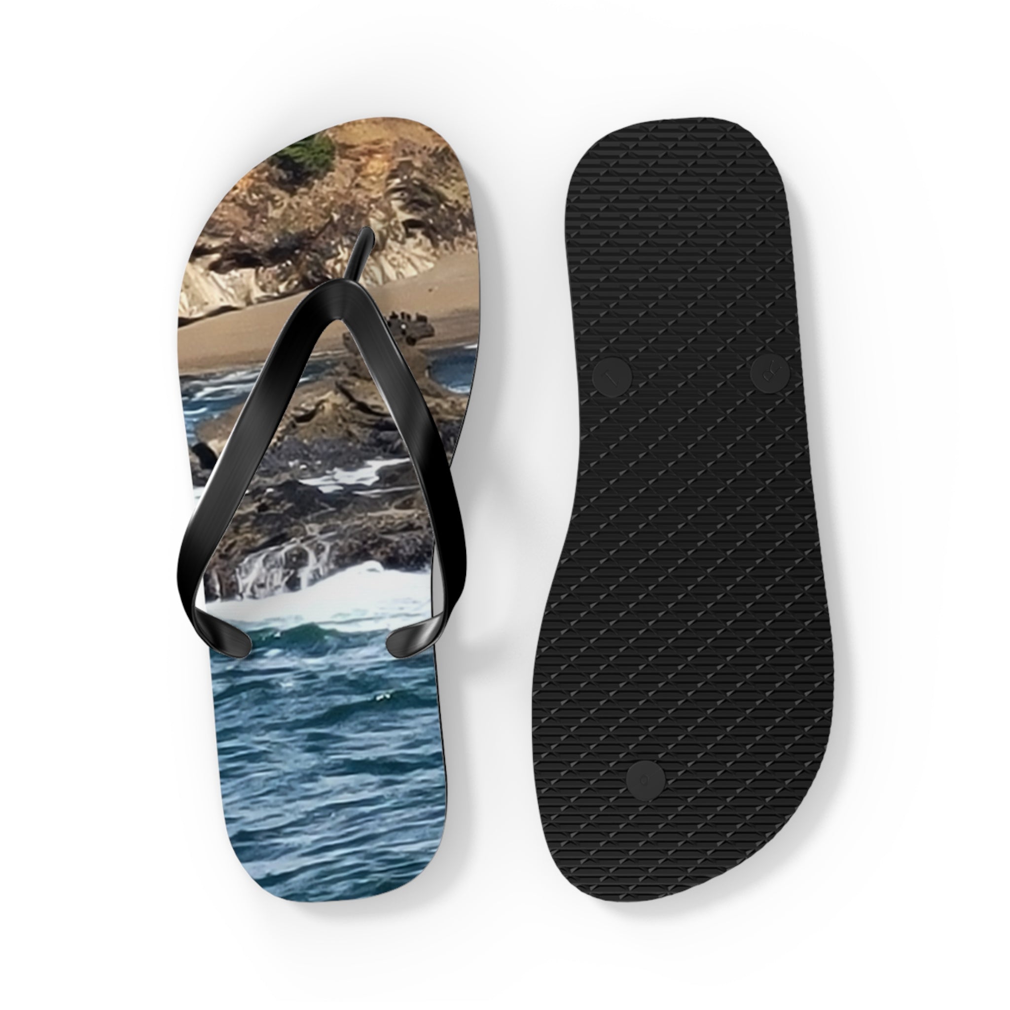 Flip-flops with ocean waves and rocky shore scene.